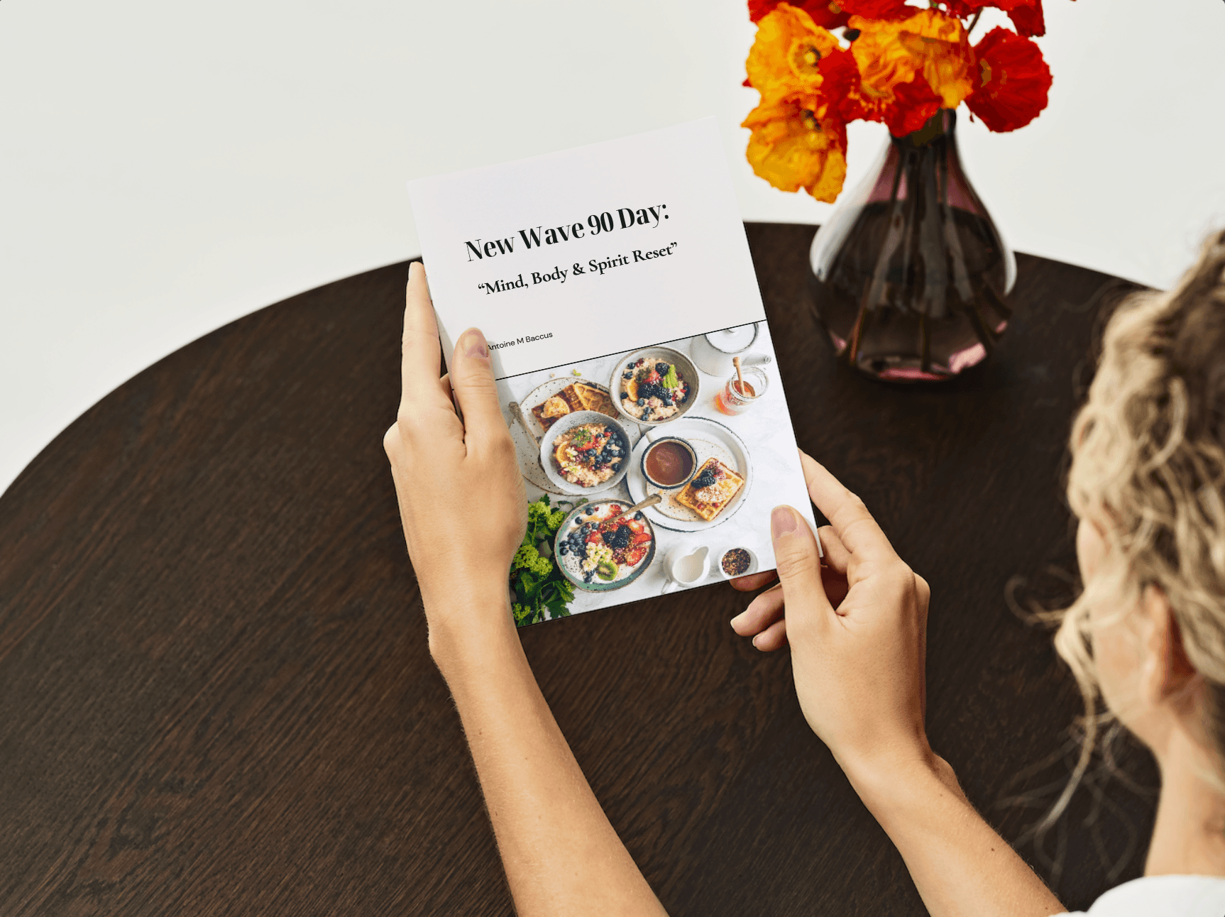 Woman holding the New Wave 90 Day: Mind, Body & Spirit Reset Transformation digital wellness program booklet on a dark wooden table. Ideal for Christian health and fitness journeys.